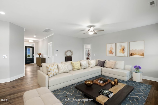 living room featuring dark hardwood / wood-style flooring and ceiling fan