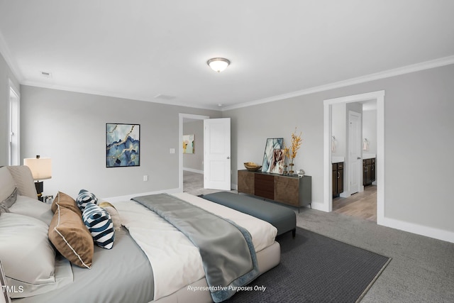 bedroom featuring crown molding, ensuite bathroom, and light colored carpet