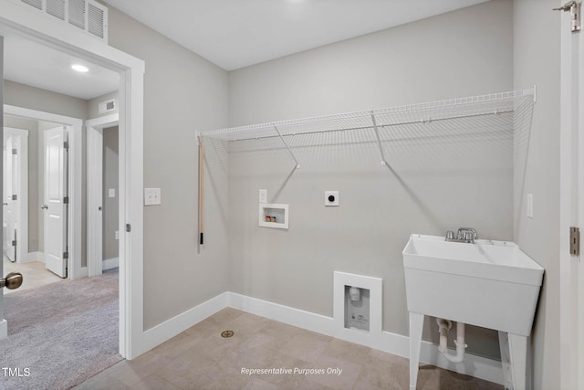 washroom with washer hookup, electric dryer hookup, and light colored carpet