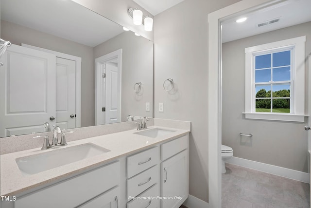 bathroom featuring vanity and toilet