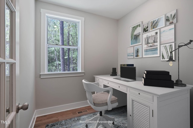 home office with wood-type flooring