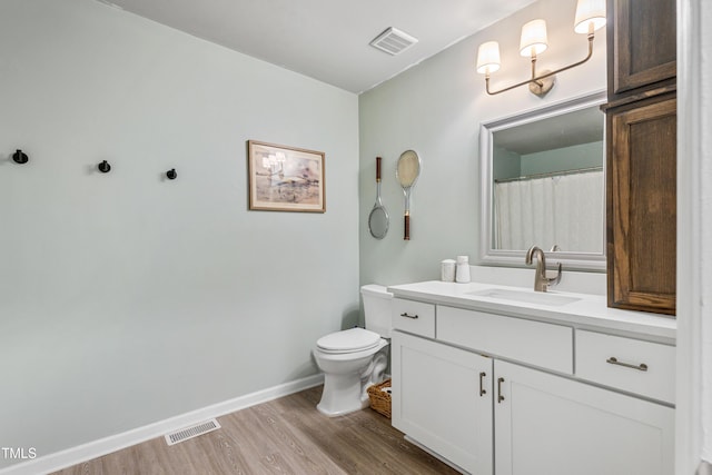 bathroom featuring hardwood / wood-style floors, vanity, and toilet