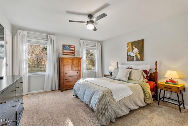 bedroom featuring ceiling fan and light carpet