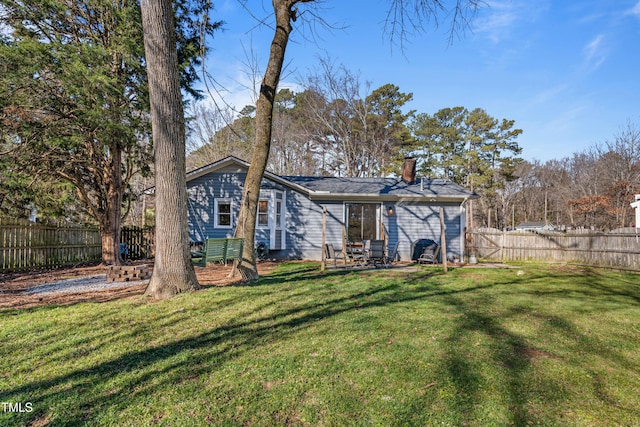 rear view of property with a yard