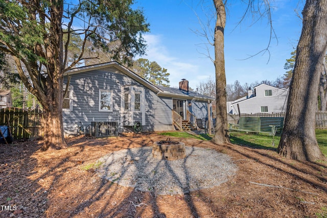 rear view of house featuring a fire pit