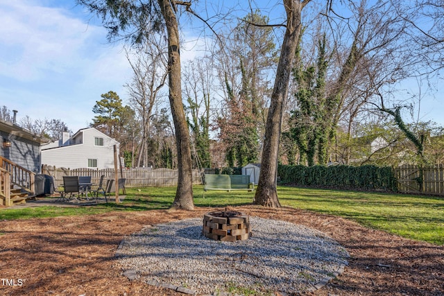 view of yard featuring a fire pit and a storage unit