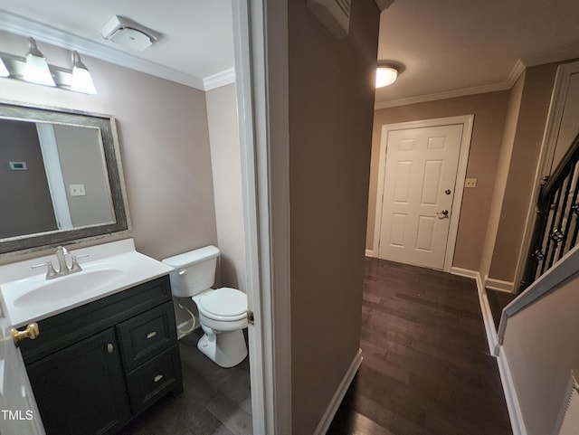 bathroom featuring crown molding, vanity, wood-type flooring, and toilet