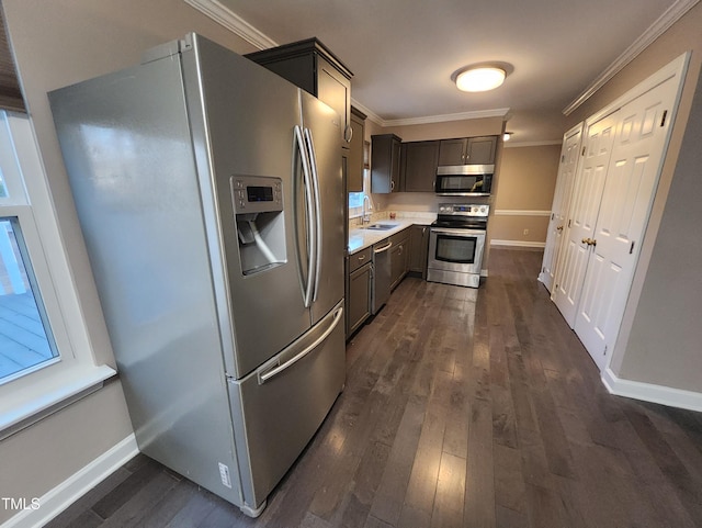 kitchen featuring dark hardwood / wood-style floors, crown molding, sink, and appliances with stainless steel finishes