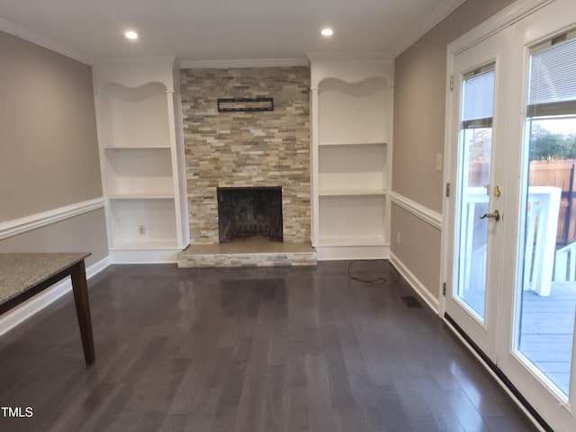 unfurnished living room with a stone fireplace, crown molding, and dark hardwood / wood-style flooring