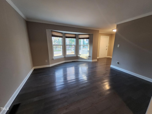 empty room featuring dark hardwood / wood-style floors and ornamental molding