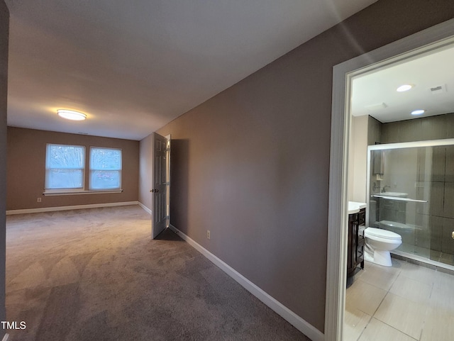 hall featuring light colored carpet