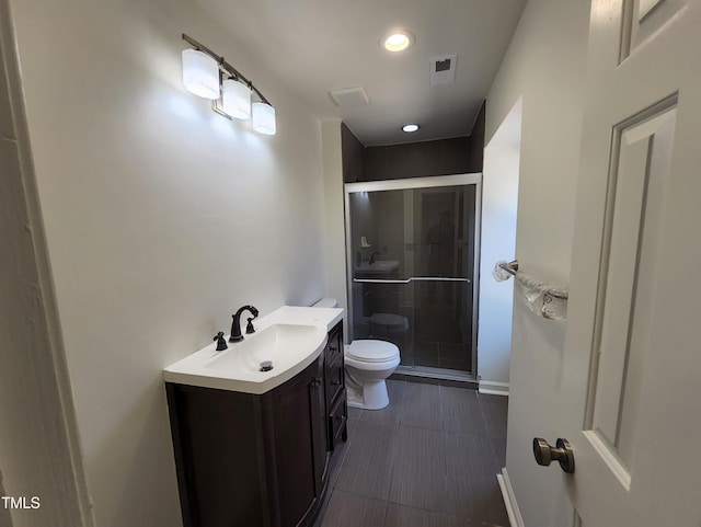 bathroom featuring walk in shower, vanity, and toilet