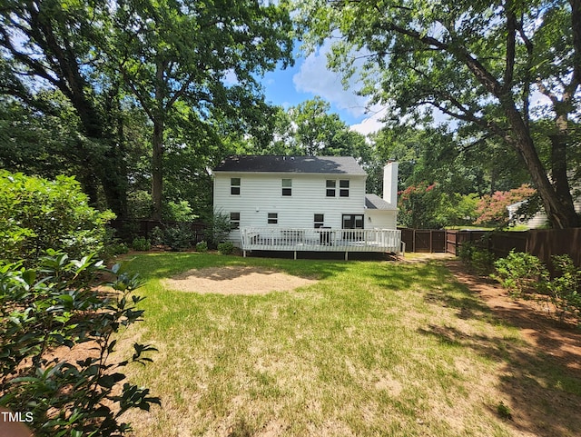 4300 Hickory Ridge Dr, Raleigh, NC 27609 - back of property with a fenced backyard, a chimney, and a wooden deck