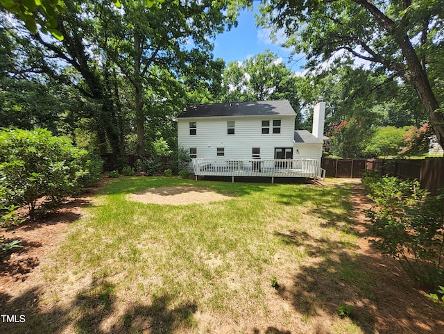4300 Hickory Ridge Dr, Raleigh, NC 27609 - back of property featuring a fenced backyard, a chimney, and a deck