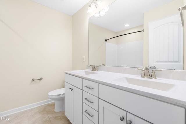 bathroom featuring tile patterned floors, vanity, and toilet