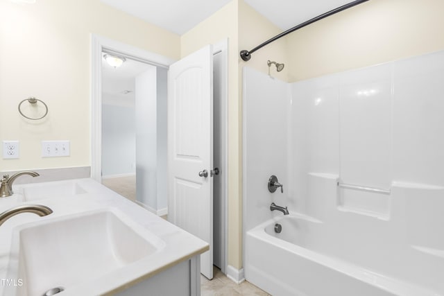 bathroom featuring shower / bathing tub combination, sink, and tile patterned floors