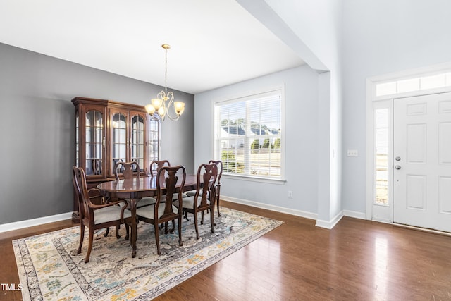 dining room featuring dark hardwood / wood-style flooring and a chandelier