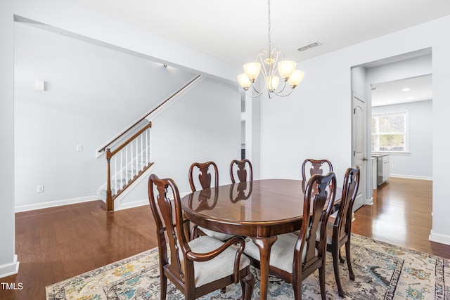 dining space featuring a chandelier and dark wood-type flooring