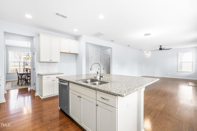 kitchen with a center island with sink, ceiling fan, white cabinets, and sink