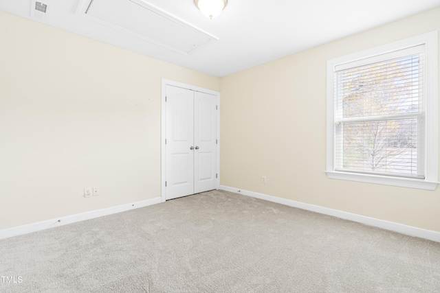 carpeted spare room featuring a healthy amount of sunlight