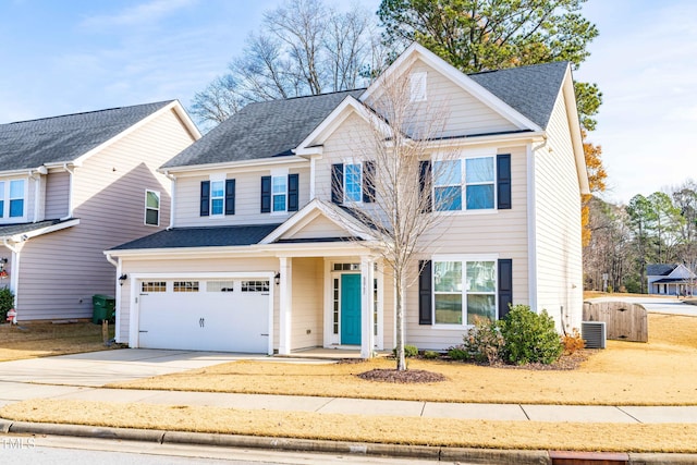 view of front of property featuring cooling unit and a garage