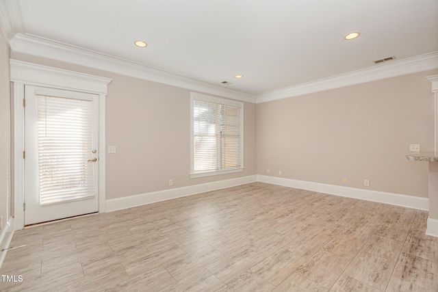 unfurnished room featuring crown molding