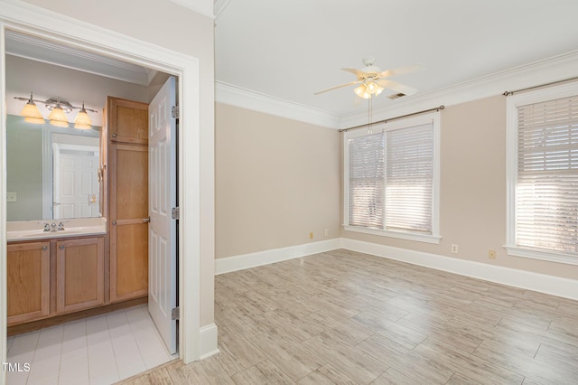 spare room featuring light hardwood / wood-style flooring, ceiling fan, ornamental molding, and sink