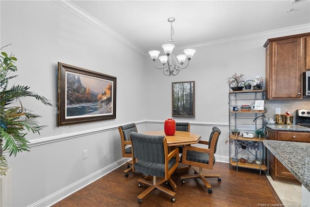 dining room with hardwood / wood-style flooring, an inviting chandelier, and ornamental molding