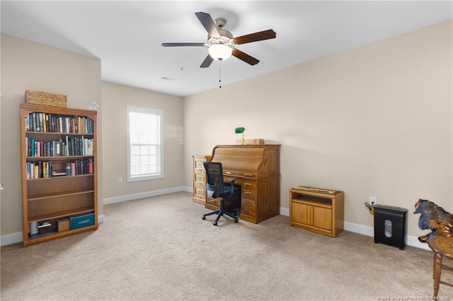 home office featuring light carpet and ceiling fan