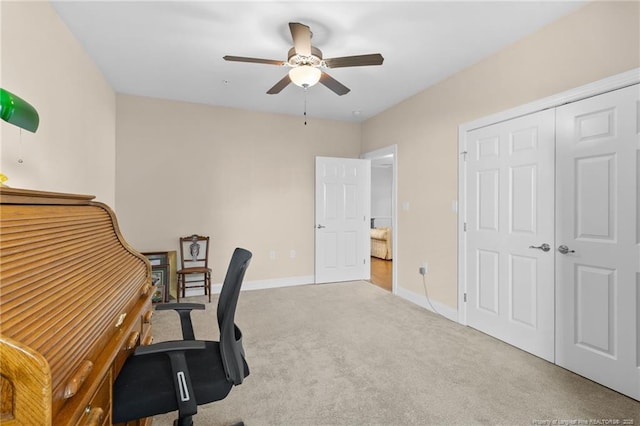 carpeted office featuring ceiling fan