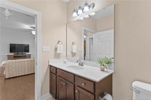 bathroom with ceiling fan, vanity, and toilet