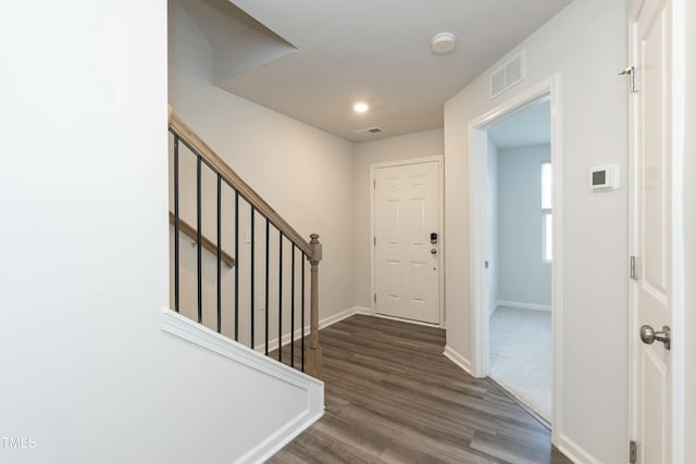 foyer with dark hardwood / wood-style floors