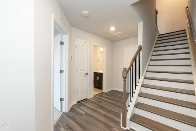 stairs featuring hardwood / wood-style flooring