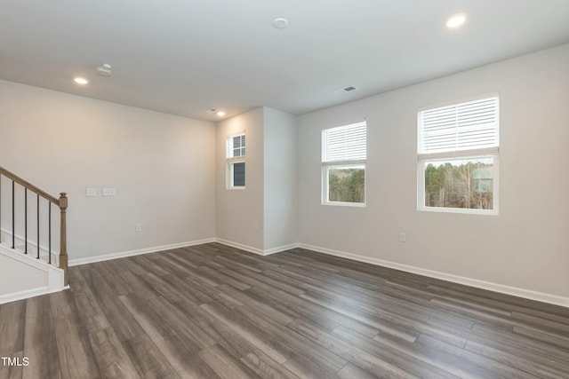 unfurnished room with dark hardwood / wood-style flooring