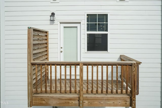 view of exterior entry with a wooden deck