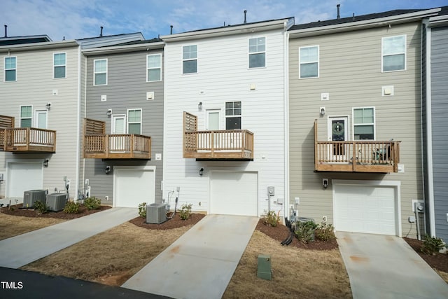 back of property featuring a garage and central air condition unit