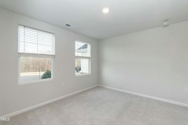 spare room featuring light colored carpet