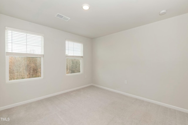 spare room with light colored carpet