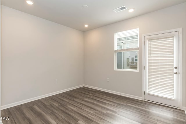 spare room with dark hardwood / wood-style floors