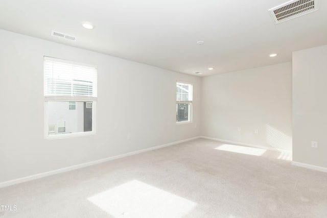 spare room with light colored carpet