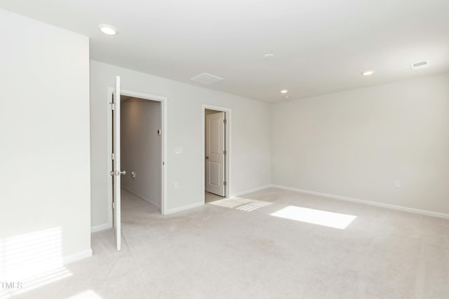 unfurnished room with light colored carpet