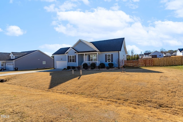 view of front of house featuring a garage, covered porch, and a front lawn