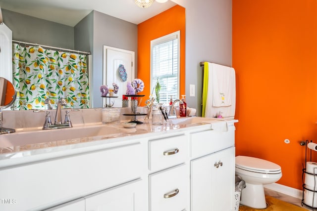 bathroom featuring vanity and toilet