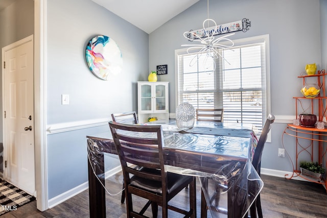 dining space featuring lofted ceiling, a chandelier, and dark hardwood / wood-style flooring