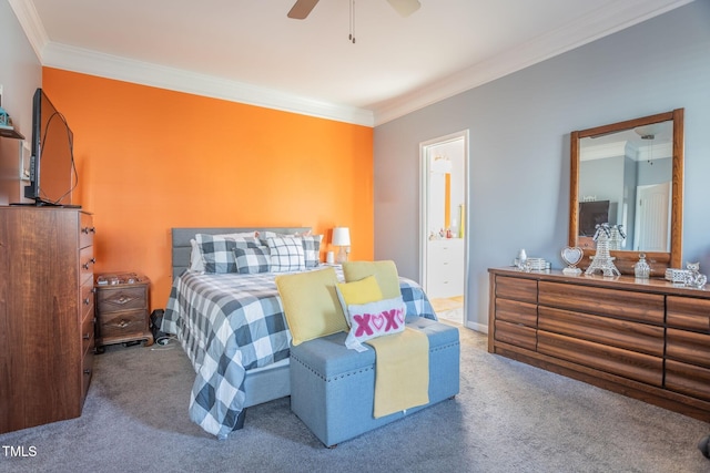 carpeted bedroom featuring ornamental molding and ensuite bath