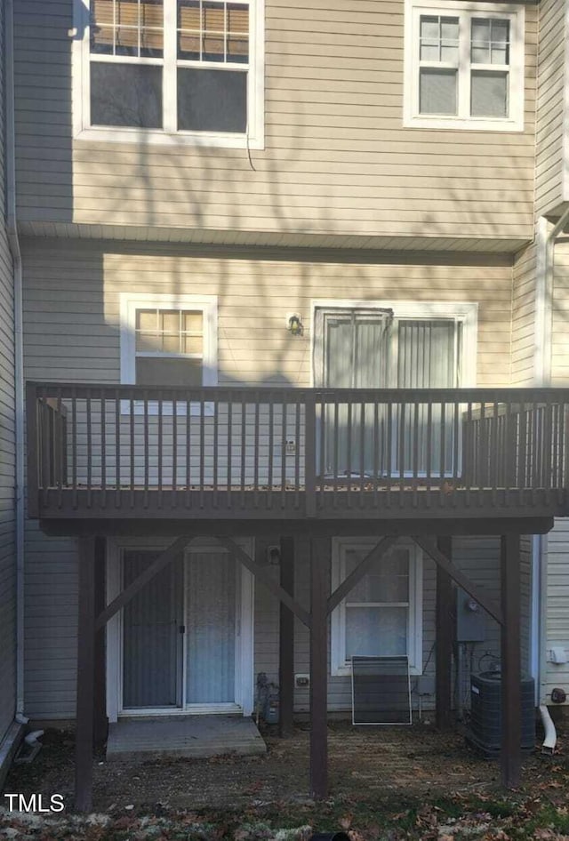 back of house featuring central AC and a deck