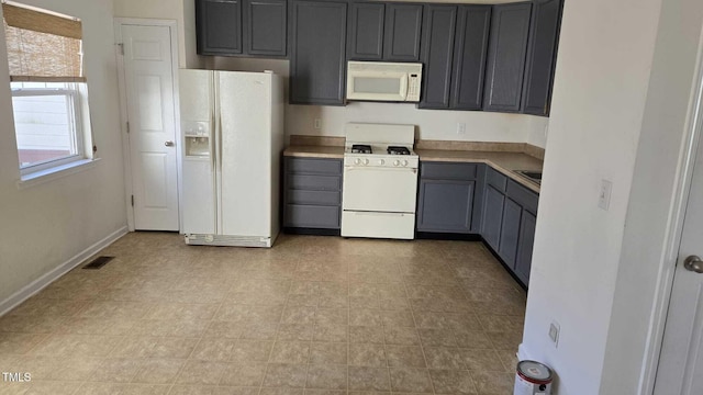 kitchen featuring white appliances and gray cabinetry