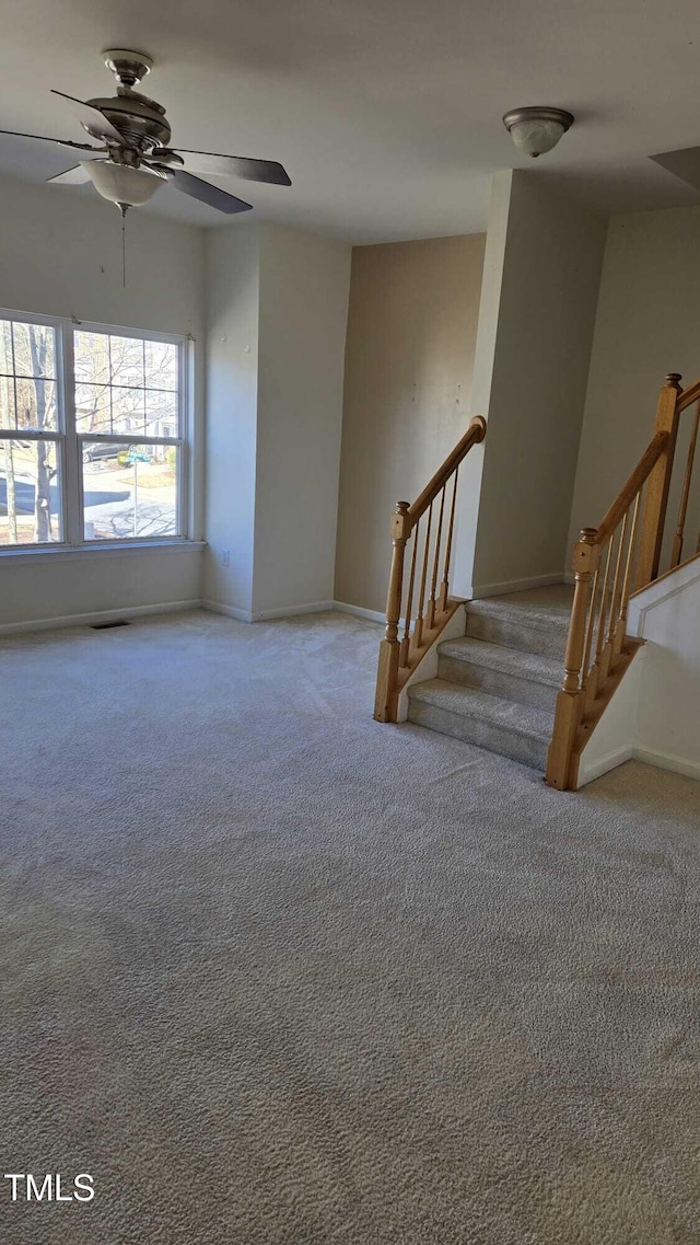 interior space with ceiling fan