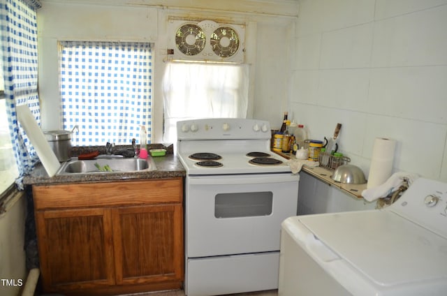 kitchen with white electric range oven, a healthy amount of sunlight, sink, and washer / clothes dryer