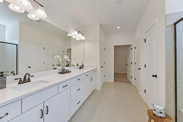 bathroom with tile patterned flooring, vanity, and an enclosed shower